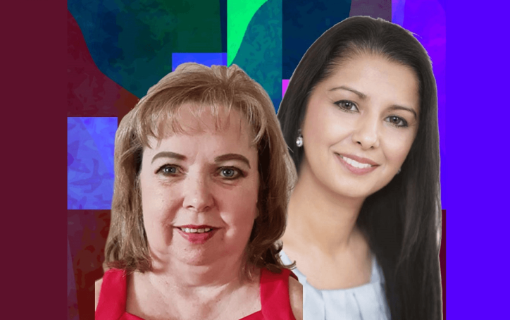 Two women smiling in front of a colorful, abstract geometric background.